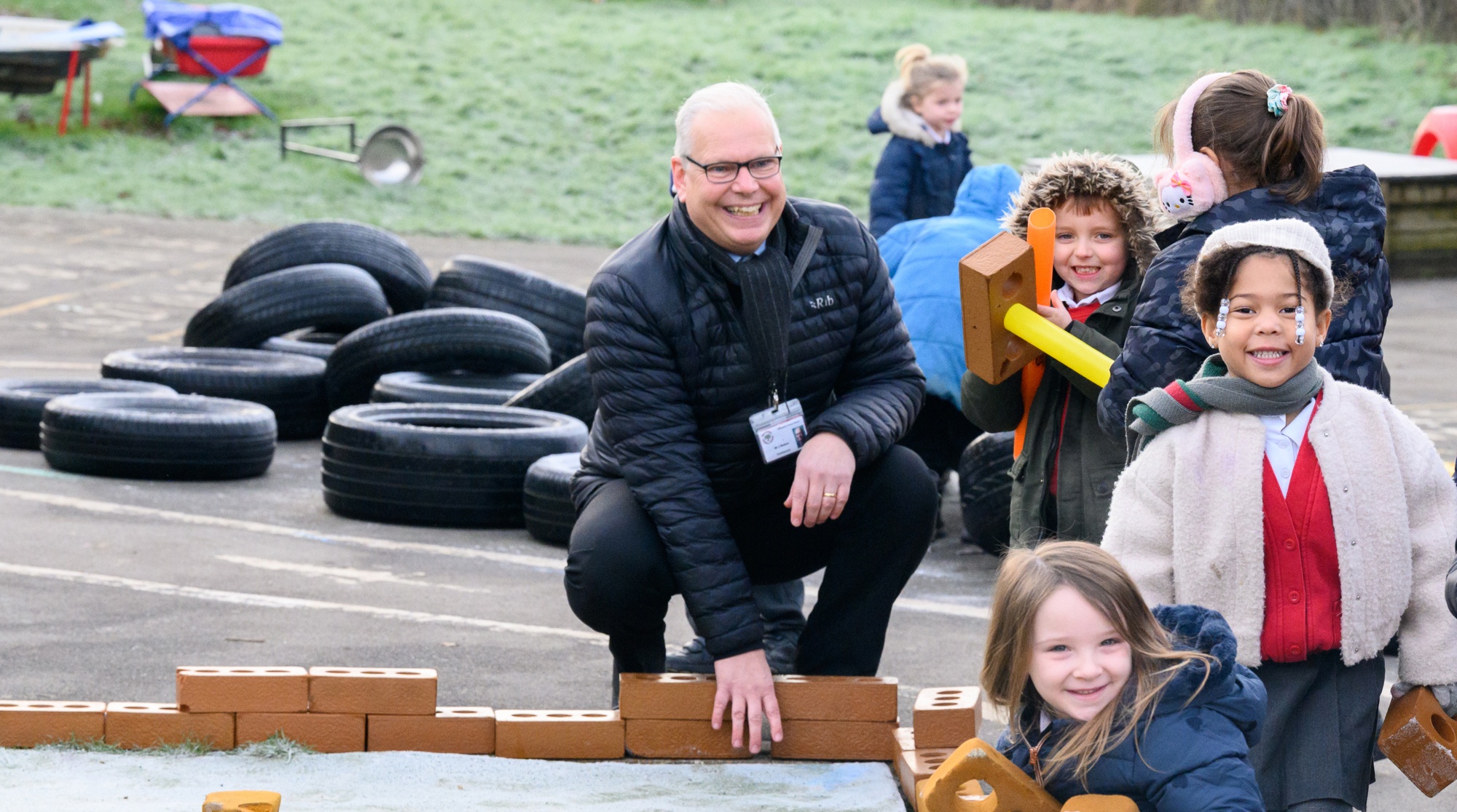 Headteacher Jonathan Walters in the playground with some of the Tweeddale pupils.